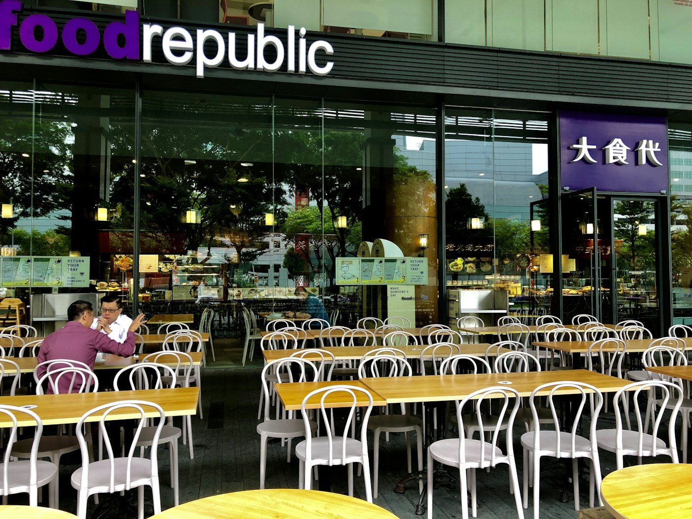 Interior of a Singapore kopitiam with marble tables and morning light