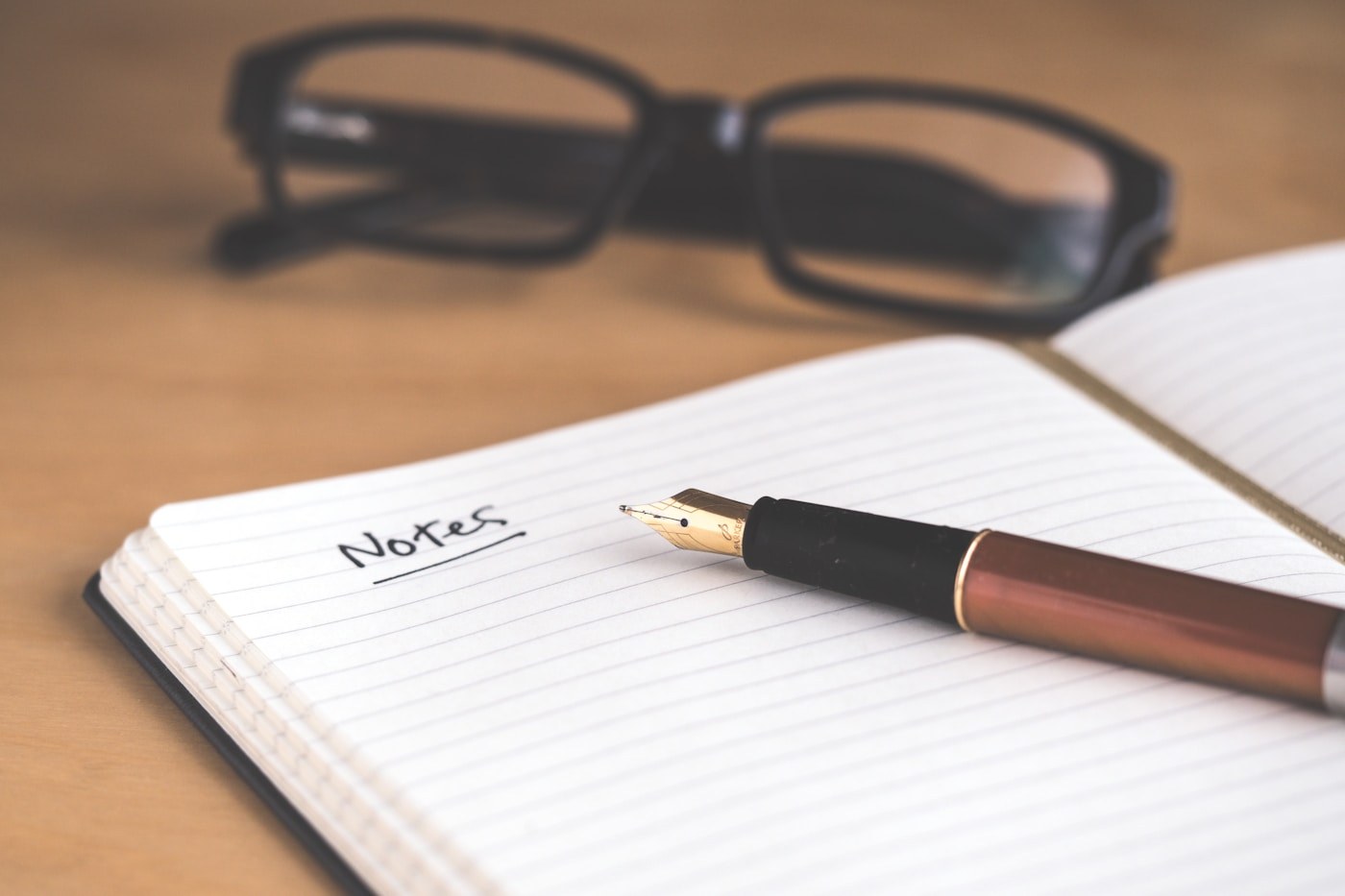 Open notebook with handwritten lines on a desk